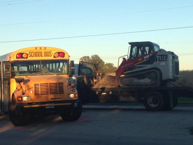 A school bus and a truck collided on Monday afternoon, sending 13 students to hospitals, two with serious injuries. (Photo: Molly Balkenbush/WDAF-TV)