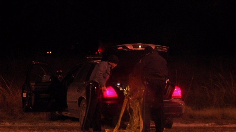 Police investigate a body found at NW Barry Rd. & NW Conant Ave.