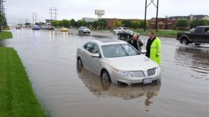 Amarillo, Texas, police officers make an emergency water rescue of a stranded motorist after heavy rain showers flood much of the city. (Michael Schumacher/The Amarillo Globe News via AP)
