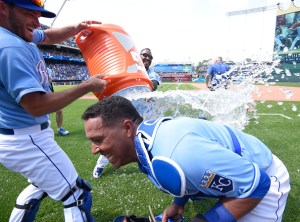KANSAS CITY, MO - JUNE 7:  Salvador Perez #13 of the Kansas City Royals is doused with water by Drew Butera and Jarrod Dyson as they celebrate a 4-3 win against the Texas Rangers at Kauffman Stadium on June 7, 2015 in Kansas City, Missouri. (Photo by Ed Zurga/Getty Images)