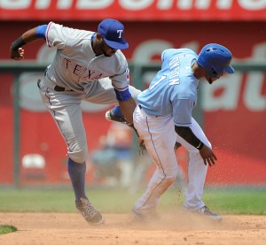 KANSAS CITY, MO - JUNE 6: Jarrod Dyson #1 of the Kansas City Royals slides into second for a steal past Hanser Alberto #68 of the Texas Rangers in the third inning at Kauffman Stadium on June 6, 2015 in Kansas City, Missouri. (Photo by Ed Zurga/Getty Images)