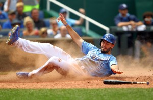 Eric Hosmer #35 of the Kansas City Royals slides safely into home plate to score during the game against the Tampa Bay Rays at Kauffman Stadium on July 9, 2015 in Kansas City, Missouri.  (Photo by Jamie Squire/Getty Images)