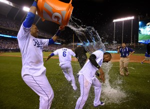  Jarrod Dyson #1 and Lorenzo Cain #6 of the Kansas City Royals are doused with water by Salvador Perez #13 of the  after a 3-2 win over the Minnesota Twins in ten innings at Kauffman Stadium on July 3, 2015 in Kansas City, Missouri. (Photo by Ed Zurga/Getty Images)