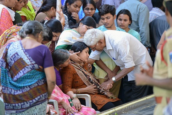 Sunayana Dumala (C), wife of killed Indian engineer Srinivas Kuchibhotla, who was shot dead in the US state of Kansas, is consoled by family members prior to performing the last rites at his funeral in Hyderabad on February 28, 2017. Thousands of Indians visit the United States every year for work or study, and the killing of 32-year-old engineer Srinivas Kuchibhotla in a Kansas bar last week has caused shockwaves around the country. / AFP / NOAH SEELAM (Photo credit should read NOAH SEELAM/AFP/Getty Images)